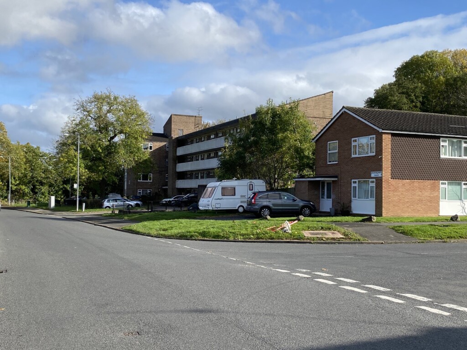 Auxerre House, a four-storey block of flats, with houses beside it